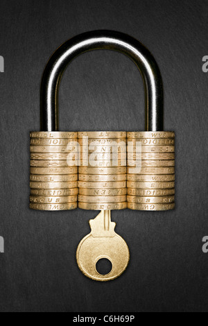 Financial Security concept. Padlock made form pound coins with a gold key inserted, signifying Financial Security Stock Photo