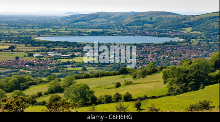 View from the Mendip Hills at Stoke Camp over Cheddar town and reservoir to Crook Peak and the Bristol Channel in Somerset Stock Photo