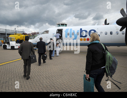 Passengers boarding a FlyBe Bombardier Dash-8 aircraft at Southampton (Eastleigh) international airport, Hampshire, England. Stock Photo