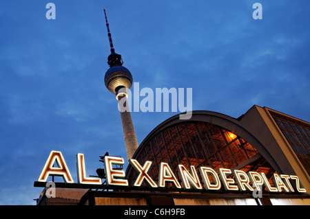 Night shot of the train station Berlin Alexanderplatz with the famous TV tower in the background.