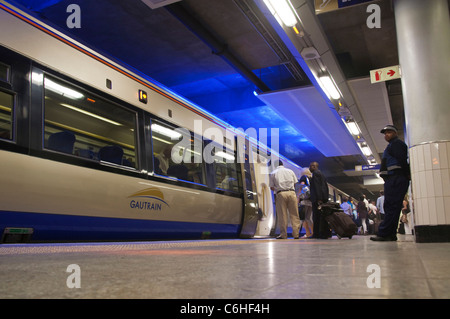 Commuters climbing onto the Gautrain at Sandton Station en route to the airport Stock Photo