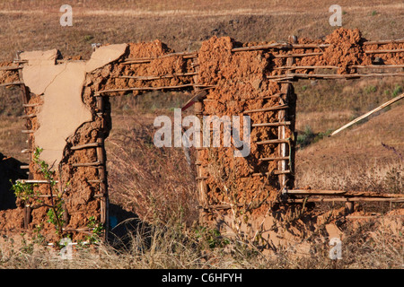 A derelict house made from a traditional wood and mud building materials Stock Photo