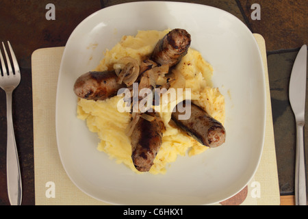 A plate full of sausage and mash with fried onions Stock Photo
