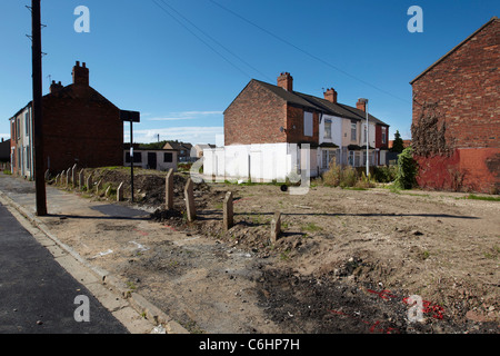 A row of empty abandoned derelict boarded up houses near Woodcock street, Kingston upon Hull, UK Stock Photo