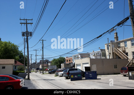 local electricity power lines and distribution in back alley of shops and houses in the french quarter winnipeg manitoba canada Stock Photo