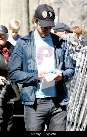 Bradley Cooper texting on his cell phone while on the film set for his new movie 'The Dark Fields' shooting on location near Stock Photo