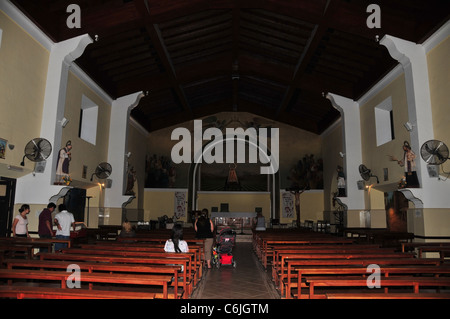 Interior view of Virgin of Carrodilla Church (pews, statues, 6 tourists), Mendoza, Argentina Stock Photo