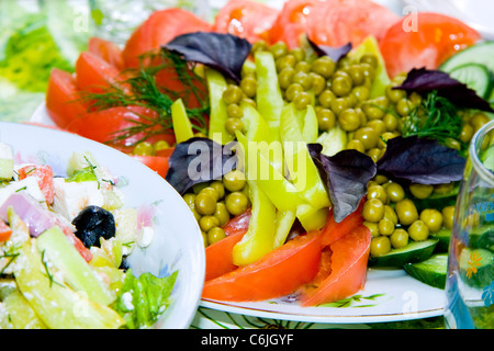 Fresh salad with tomatoes, peas, cucumber, basil, green pepper Stock Photo