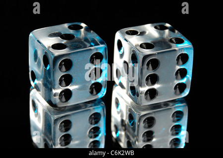 Pair of clear dice isolated on black background with reflection Stock Photo