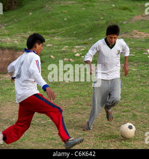Two men playing soccer, Sacred Valley, Cusco Region, Peru Stock Photo