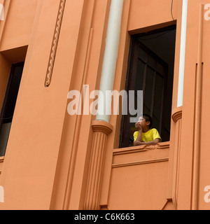 Boy looking through the window of a building in Historic Centre of Lima, Lima, Peru Stock Photo