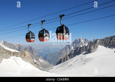 cable cars cross the Mont blanc glacier on route from the Helbronner telepherique station on the way to Aiguille du midi Stock Photo