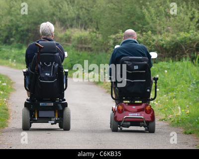 Couple on mobility scooters, Bude, Cornwall, UK Stock Photo