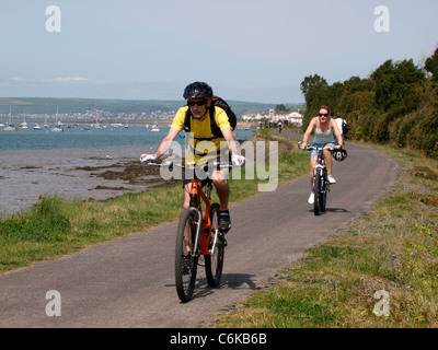 Riders on the cycle path, Instow, North Devon, UK Stock Photo