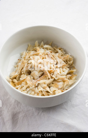 Shredded cod in bowl Stock Photo