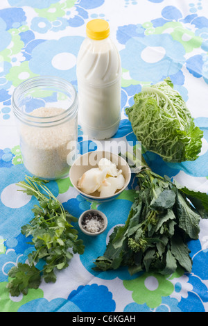 Sauteed cabbage and rapeseed leaves with coconut, ingredients Stock Photo