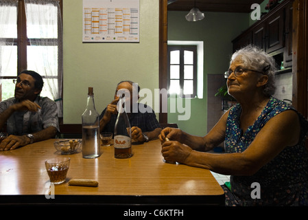 Seniors sitting around table having drinks Stock Photo