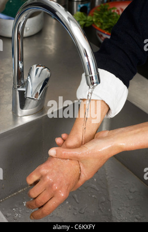 Washing hands before cooking Stock Photo