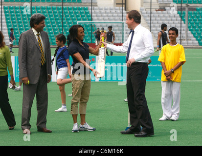 British Prime Minister David Cameron, with Dame Kelly Holmes, playing cricket, at the National Stadium in New Delhi, India, Stock Photo