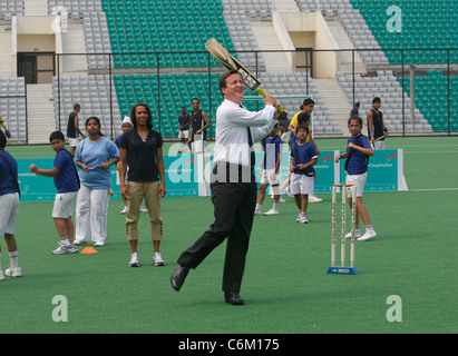 British Prime Minister David Cameron, with Dame Kelly Holmes, playing cricket, at the National Stadium in New Delhi, India, Stock Photo