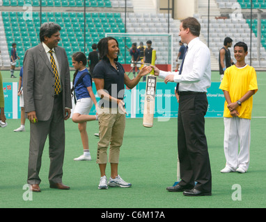 British Prime Minister David Cameron, with Dame Kelly Holmes, playing cricket, at the National Stadium in New Delhi, India, Stock Photo