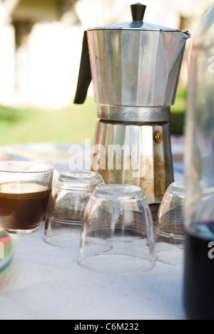 Espresso maker and glasses on outdoor table Stock Photo