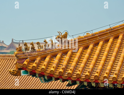 detailed view of carved figurines on a colorful chinese roof in beijings forbidden city Stock Photo