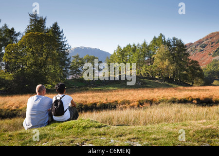 A mixed race couple enjoy a scenic view in Borrowdale, Lake District, Cumbria, UK. Caucasian man, Indian Asian woman. Stock Photo