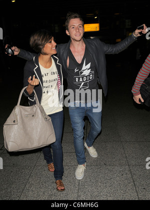 Frankie Sandford from girl group The Saturdays, and Danny Jones from boy band McFly arriving at Heathrow airport, having Stock Photo