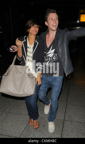 Frankie Sandford from girl group The Saturdays, and Danny Jones from boy band McFly arriving at Heathrow airport, having Stock Photo