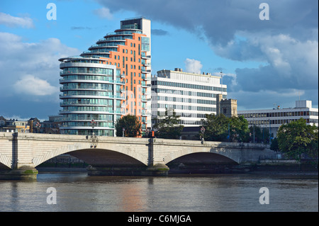 Putney Bridge, on the River Thames, London, UK, Europe, overshadowed by St Mary's Church, itself dominated by tower blocks Stock Photo
