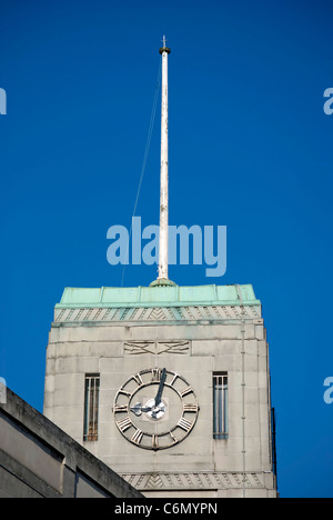 art deco clock tower with flag pole on a former electricity showroom of the early 1930s in twickenham, middlesex, england Stock Photo