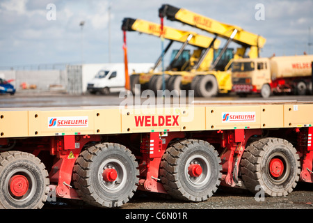 Wind turbines and low loader on the quayside at Mostyn, destined for the Walney offshore wind farm. Stock Photo