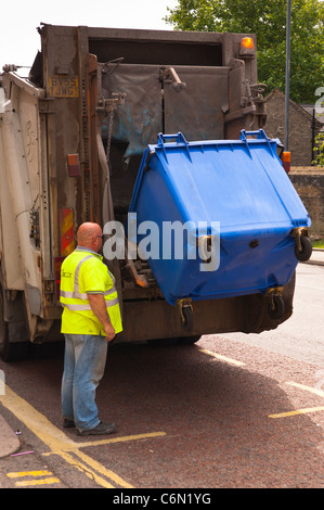 A bin lorry emptying an industrial wheely bin in Norwich , Norfolk , England , Britain , Uk Stock Photo