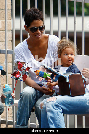 Actress Halle Berry dresses her daughter Nahla in an identical outfit to her own for a day of fun at the park. The X-Men star Stock Photo