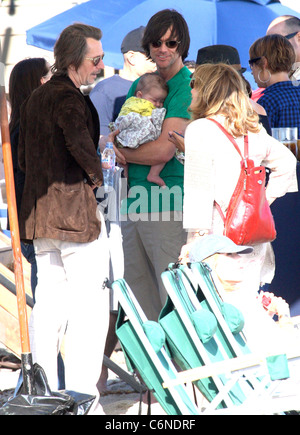 Jim Carrey holding his grandson Jackson Santana while talking to Gary Oldman on Malibu Beach Malibu, California - 04.07.10 Stock Photo