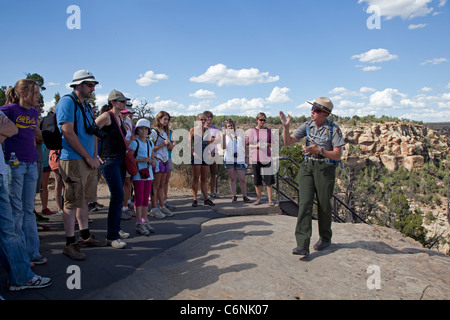 A Park Ranger Talks with Visitors on a Tour of the Balcony House cliff dwelling at Mesa Verde National Park Stock Photo