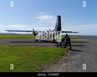 dh Loganair aircraft Scotland PAPA WESTRAY ORKNEY ISLES Baggage handler loading plane island small airplane islands airport luggage ground crew
