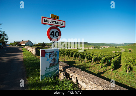 Road sign at the entrance to Meursault village with vineyards and the village of Auxey Duresses in the distance Stock Photo