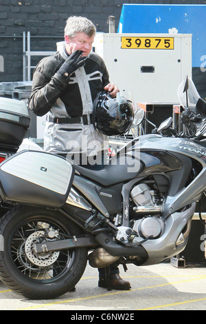 Adrian Chiles Arrives by motorcycle for a photo shoot at a studio in North London to promote his new ITV show London, England - Stock Photo