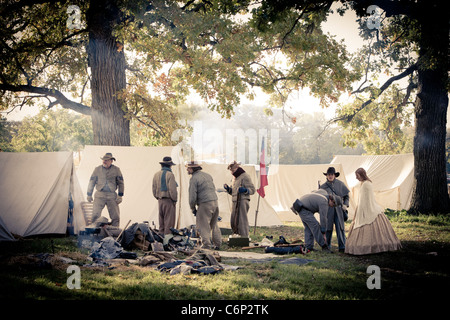 Civil war reenactors stand near tents in the early morning Stock Photo