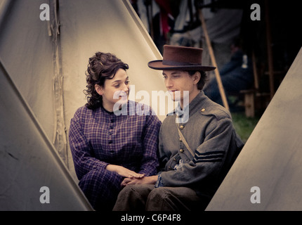 A young couple in period clothing at a civil war reenactment campsite Stock Photo