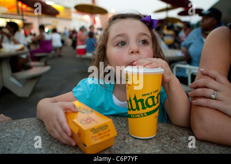 Caterina Miserandino sips some cola as she holds a hod dog at the original Nathan's Famous restaurant stands on Coney Island Stock Photo