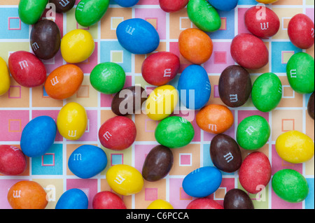 M & M s on colourful square patterned background Stock Photo