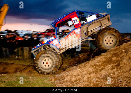 Modified Land Rover challenge vehicle competing at night in Manby Stock Photo