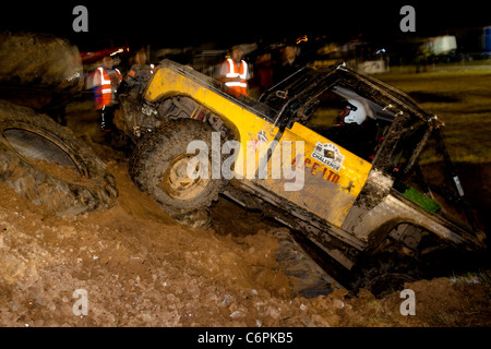 Modified Land Rover challenge vehicle competing at night in Manby Stock Photo