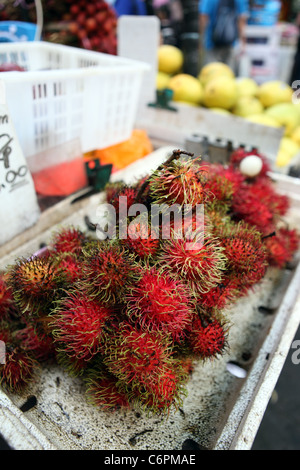 Detail of Rambutan on a fruit stand in Chinatown. Stock Photo
