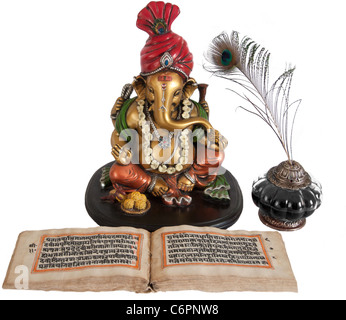 Lord Ganesha with old mythological book and inkpot, having peacock feather in it. Stock Photo