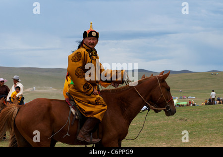 Mongolian Man in traditional clothing, Horse racing competition, Naadam Festival (horse racing ground), Ulaanbaatar, Mongolia. credit: Kraig Lieb Stock Photo