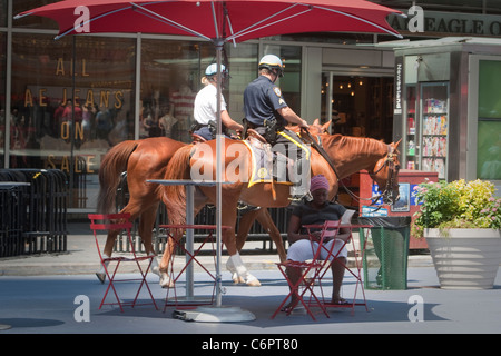 NYPD officers on horseback are pictured on Times Square in the New York City borough of Manhattan, NY, Tuesday August 2, 2011. Stock Photo